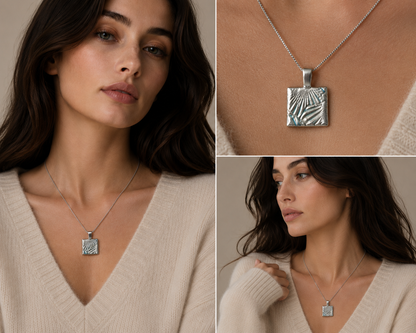 A silver pendant necklace with a textured, geometric square design is shown worn by a model in three views: a close-up of the face, a close-up of the pendant, and a full upper-body view. The model is wearing a cream-colored knit sweater against a neutral beige background.
