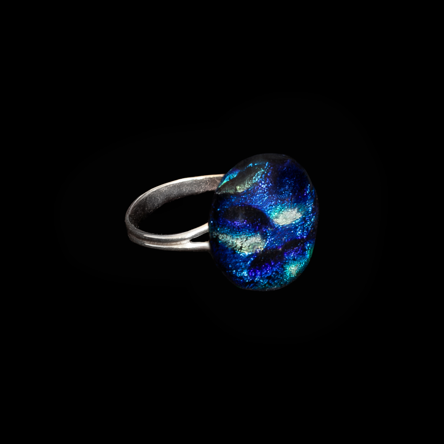 Ring with a blue and cyan glass stone on a black background