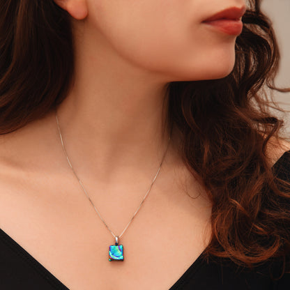 Close-up of a woman wearing a necklace with a colorful pendant.