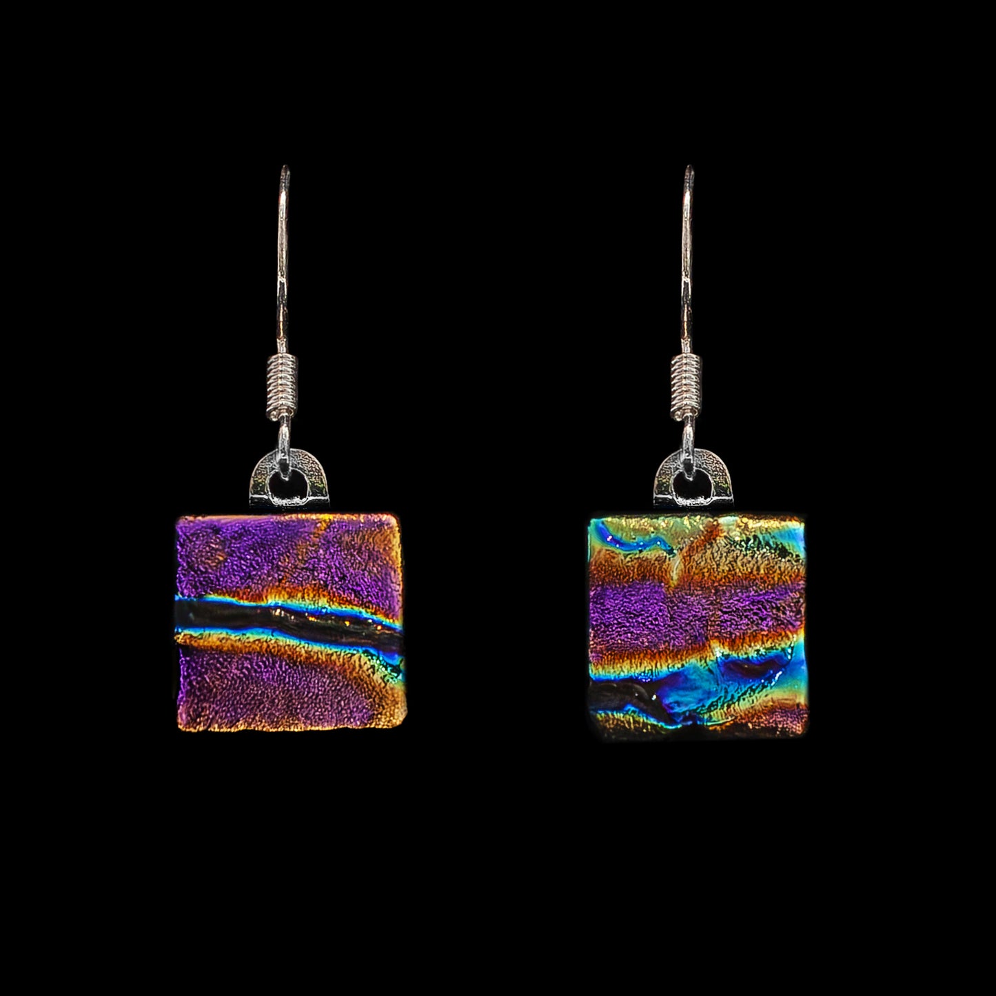 A pair of square-shaped, pink ripple dichroic glass drop earrings with metal hooks.