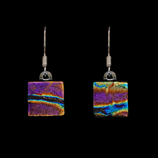 A pair of square-shaped, pink ripple dichroic glass drop earrings with metal hooks.
