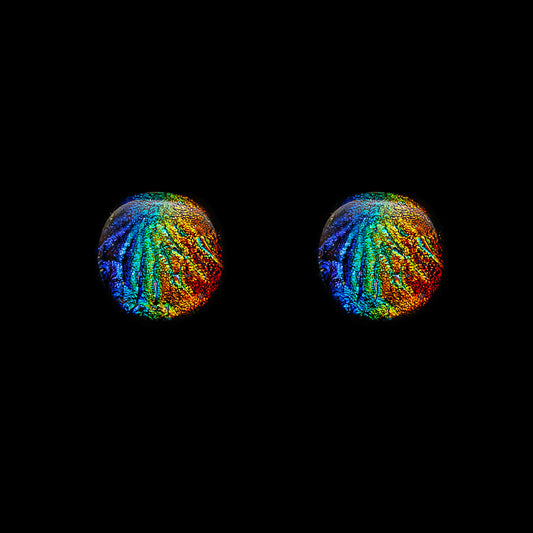 Round dichroic glass stud earrings from the Orb Collection by Invoke London, featuring a rainbow colour palette and textured Florentine finish on a domed fused glass surface.